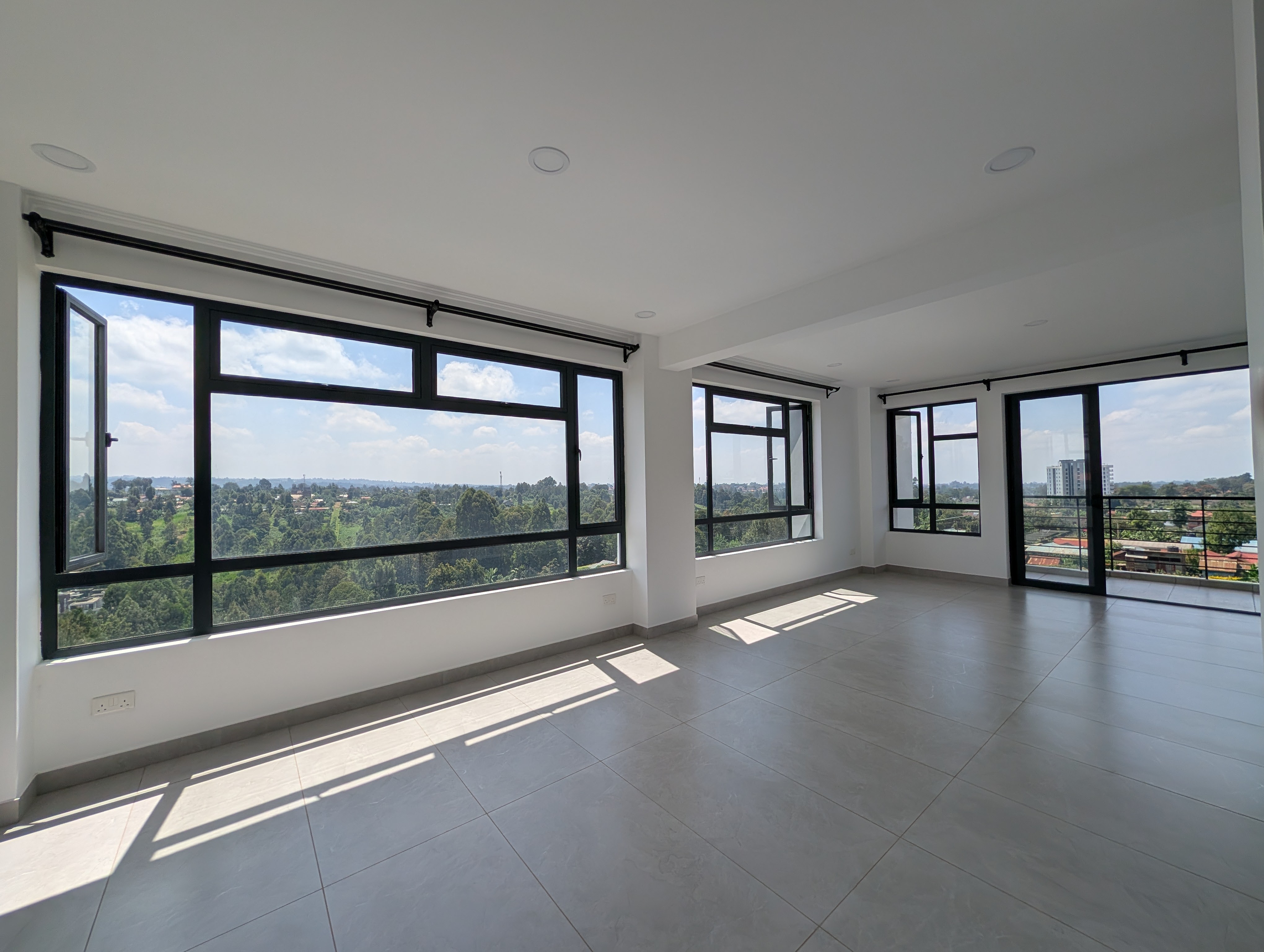 Spacious living room with panoramic windows and natural light
