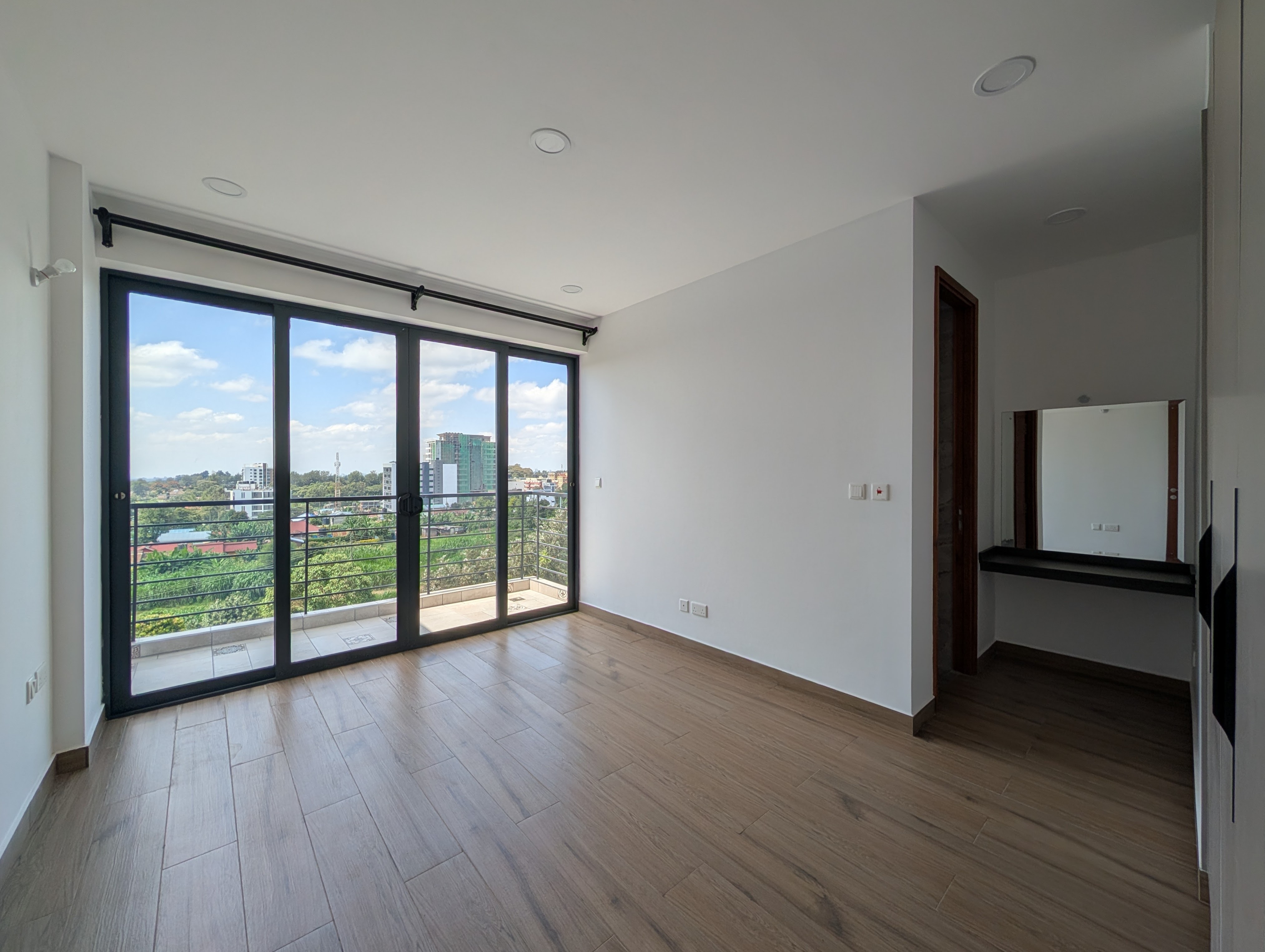 Master bedroom with wood floors and panoramic glass wall