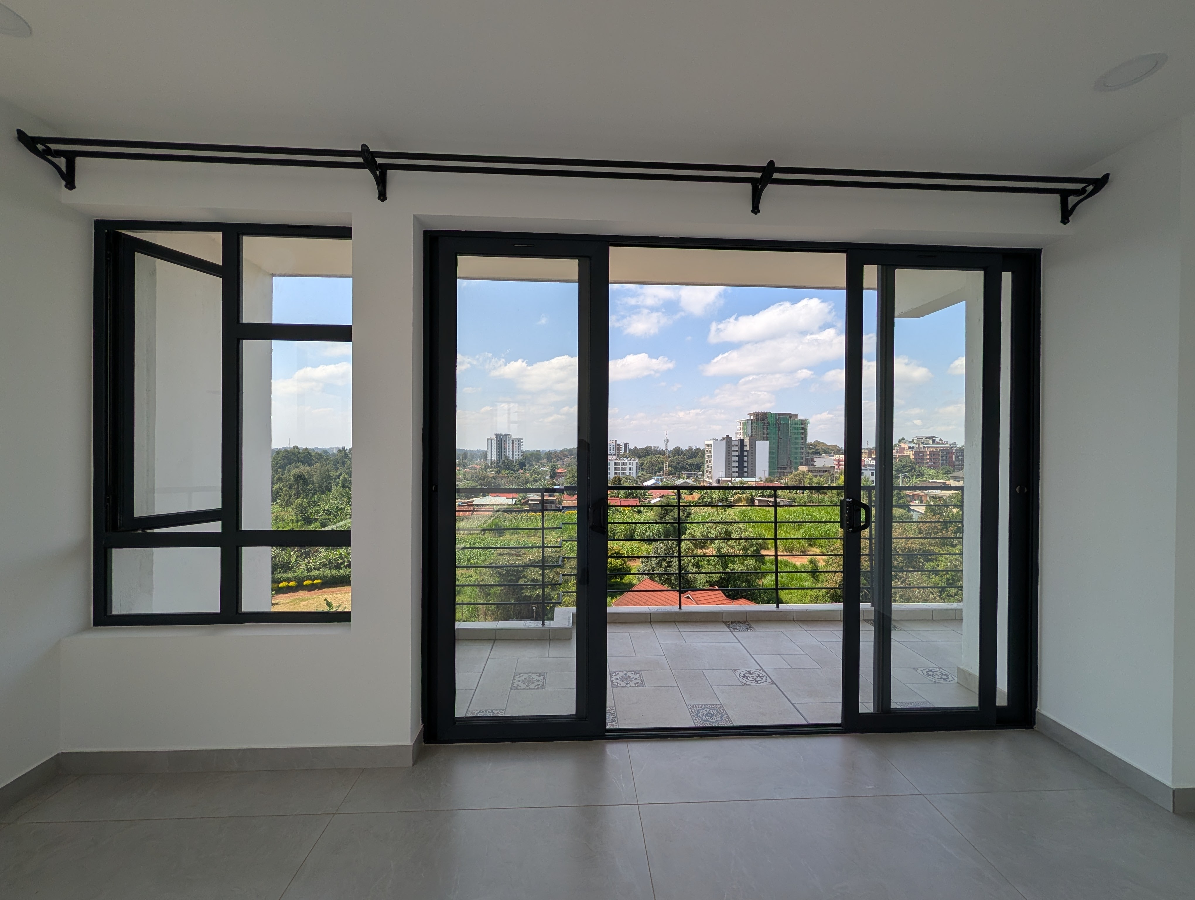 Living room with floor-to-ceiling glass and city view