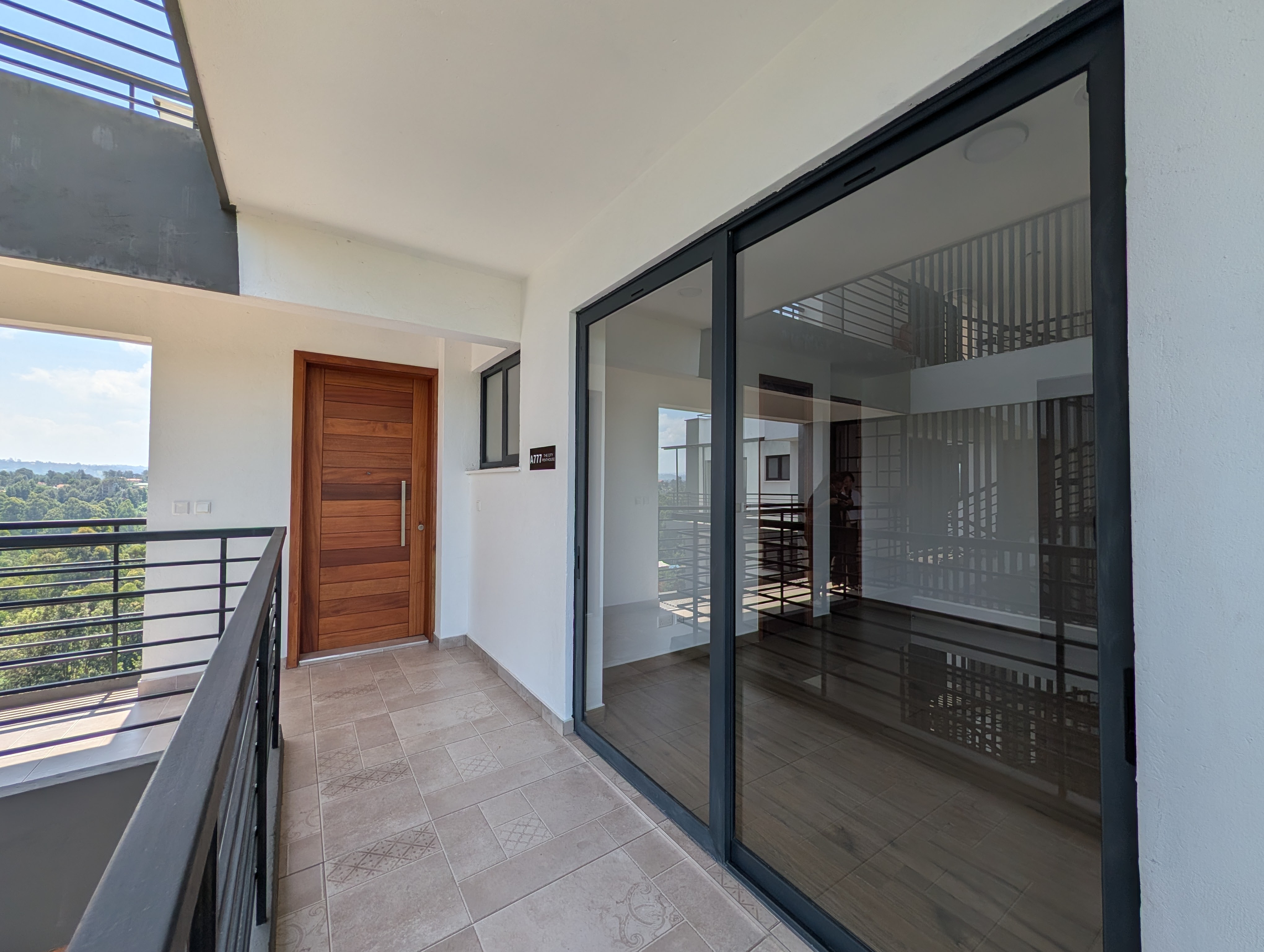 Second bedroom with floor-to-ceiling glass and city view