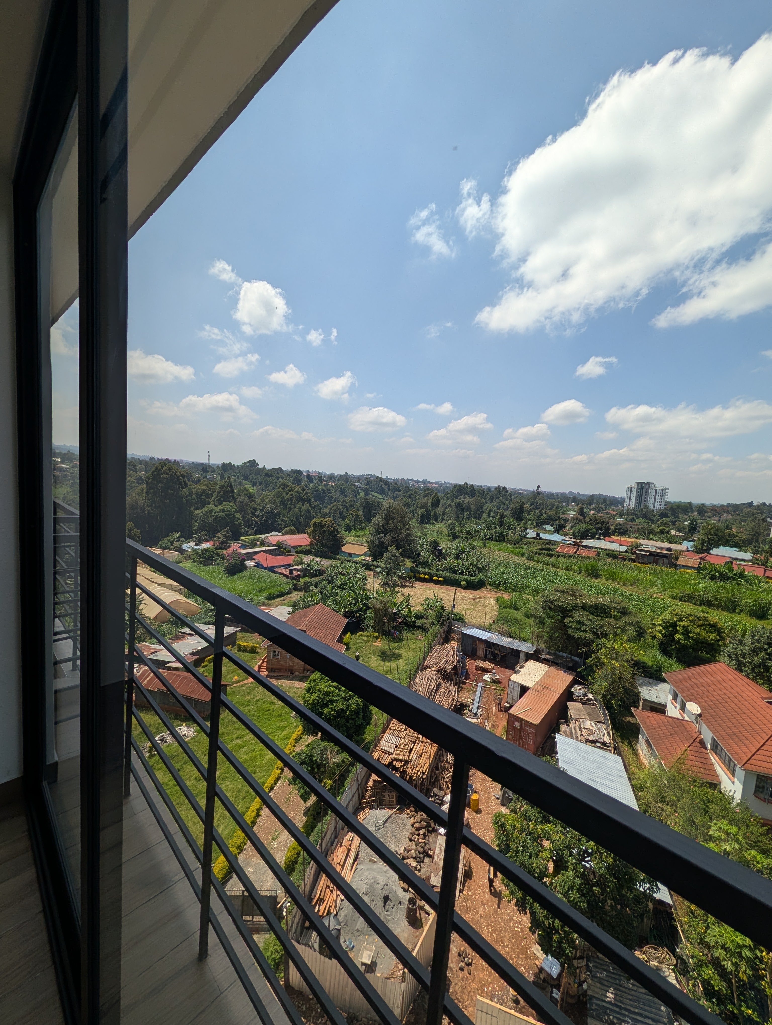 Balcony view with blue sky and green landscape